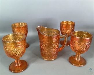 Carnival Glass Water Pitcher and Goblet Set
One matching set of orange carnival glass Imperial grape design by Imperial Glass Co. Set includes one6"Hx6"Wx3.75"D water pitcher and four (4) 5.5"H water goblets. All have manufacturer's stamp on the bottom. No visible cracks or chips.
