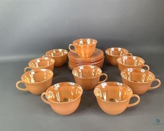 Fire King Peach Luster Teacups & Saucers
Set of ten (10) matching teacups and saucers in the Consecutive Banding design by Fire King. One saucer has a chip in the luster, otherwise most pieces have minimal to no wear on the luster.