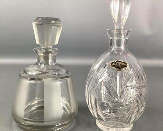 Glass Decanters
Two (2) glass decanters with stopper lids. One is made in West Germany, genuine lead crystal as marked by sticker. It is clear glass with star motif, 9.5"Hx4"W. The other is a smoky colored cut glass decanter, 7"Hx4.5"W. No visible cracks or chips.