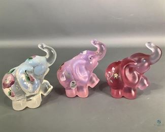 Fenton Glass Elephants
Three (3) Fenton glass elephants. One is dark pink satin with hand painted floral design, signed by A. Vanzile. One is light pink with hand painted floral design signed by B.Williams. One is white/clear glass with hand painted design, not signed. All are 4"Hx3.5"W, no visible cracks or chips.
