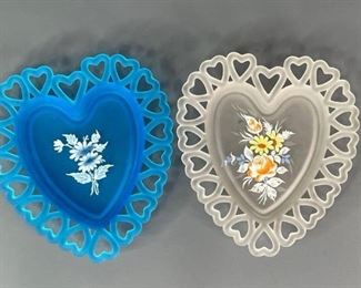 Westmoreland Satin Glass Plates
Two (2) vintage Westmoreland satin heart shaped plates. One is white with multi-colored hand painted floral design. One is blue satin glass with white floral hand painted design, center of design appears to have wear in the center. 8.25"hx7.25"W No visible chips or cracks.
