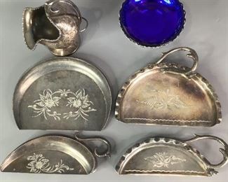 Vintage Kitchenware
Includes a small silver plated footed holder with cobalt blue glass candy bowl, silver plated sugar scuttle and four (4) crumbers. Shows signs of use.