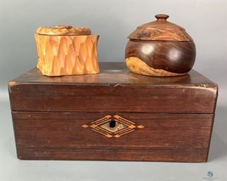 Wooden Trinket Boxes
Includes three wooden trinket boxes; one is a well-worn paper lined box measuring approx. 5" x 11" x 8.5", the small round box appears to be hand made with lid with approx. 4" diameter, and the small square box is approx. 2.5" x 3.5" and beautifully hand carved.