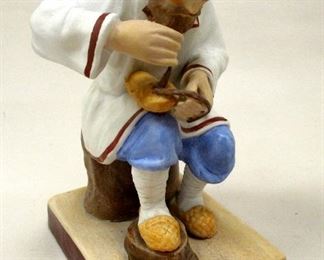 A RUSSIAN PORCELAIN FIGURE OF A BAST SHOE MAKER BY GARDNER. IMPRESSED MARK AND INK STAMPED . 5" TALL