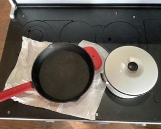 Emeril Lagasse Cast Iron Skillet & Enamelware Pot
Emerald Lagasse 10.5" cast iron skillet with silicone pot holders in good condition. Black and white enamelware pot H5" x 10" round with lid in used condition.
