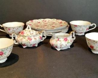 Lefton Floral China
Lefton china luncheon snack shell tea set, floral chintz. Beautiful rose pattern with gold tone trim. Some pieces the gold shows wear. Set includes four(4) 3.5"W teacups and four (4) 7.5" plates. One teacup has a tiny chip on the rim. All have manufacturer's stamp and numbered 637 on bottom. Creamer and sugar bowl with lid. All have manufacturer's stamp on bottom and numbered 663R on bottom. No other damage seen.