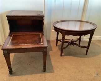 Vintage Side Tables
One is a step table with one drawer. Surface is leatherlike with gold color embossed design. 25"Hx27"Wx19"D. Table has signs of wear and scratches. Other is an oval dark wood table with removal wood trimmed glass top. 19"Hx27"Wx20"D. Scuff marks and scratches on top surfaces, edges and legs.