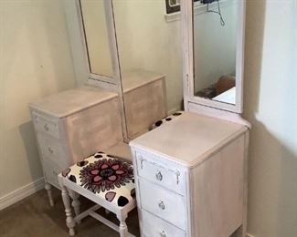 Dressing Table and Bench Chair
Vintage dressing table is painted white with 3 piece folding mirror. Center mirror is full length size. 65"Hx48"Wx18"D with six side drawers. Bench seat has pink, black and white floral textured fabric and white painted wood trim. 9"Hx19"Wx12"D. No manufacturer's labels visible on either piece.