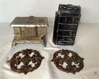 Miscellaneous Decor
Vintage miniature metal Eagle stove H5.5" x W8.5" x D6". Decorative metal candle holder H9" x W5" x D4". Two (2) metal wall decor 5" round.