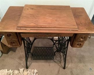 Vintage Singer Sewing Machine and Table
Table is wood with metal base and foot pedal. Four drawers with a center pull out mini drawer. 31"Hx50"W (table extended) 36"Wx18"D. Center drawer needs repair, minor scuffs and scratches on the wood. Drawers have decorative carved scrollwork. Sewing machine needle moves with turn of handle.
