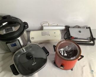 Kitchen Appliances
One vintage crock pot with glass lid, comes with electrical cord. One electric covered skillet, cord not available. One InstaPot. One Food Saver sealer with bag roll. One Hamilton Beach panini press. All are in unknown working condition.