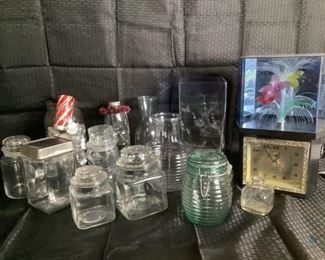 Kitchen Jars, Vases and More
Several clear glass jars with lids, all are different sizes and shapes. One green glass lidded jar. Three glass vases. One electric fiber art, unknown working condition and music box. Jar of tea lights and small candle.