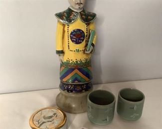 Asian Themed Decor
One ceramic statue of Asian male, made in China. 16"H. Pair of ceramic sake cups, green with white cranes. Two small covered bowls. one with floral design. One with bird and flowers with gold colored trim.