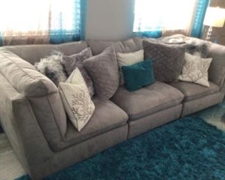X long suede type couch with pretty seaside pillows