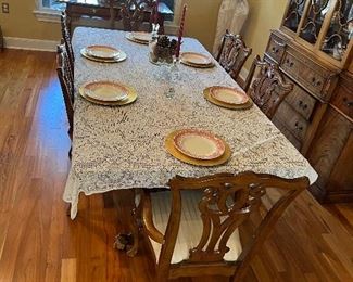 $875 ~ EXQUISITE BALL AND CLAW FOOT DINING TABLE AND SIX CHAIRS INCLUDING TWO CAPTAINS CHAIRS WITH FOUR LEAVES 