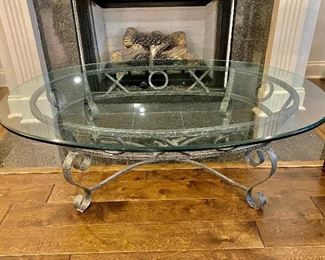 Iron base glass oval top coffee table - $130.00