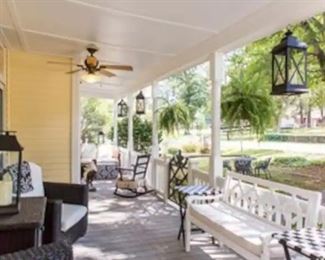 The porches are adorned with charming lanterns.and an array of comfy and welcoming furniture.