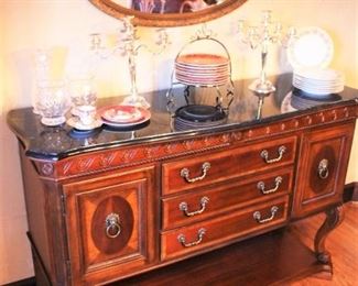 Cultured marble top sideboard shown with beautiful china, crystal, candelabras  and oval mirror.