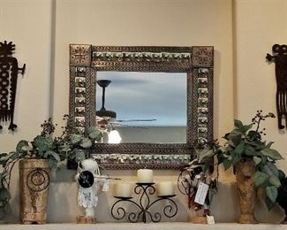 Native American art decor, cactus tile mirror, candles, and Kachinas.