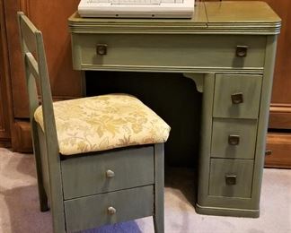 Green desk/sewing table and chair with drawers and storage inside of chair.