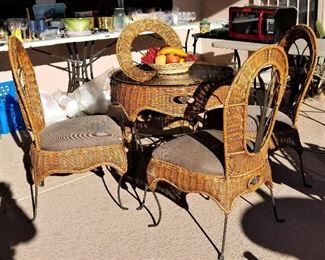Heavy duty wicker indoor/outdoor table and 4 wicker chairs.