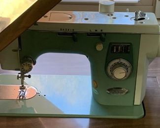 #54	Blue Deluxe Sewing machine in a mid-century Cabinet 	 $125.00 
