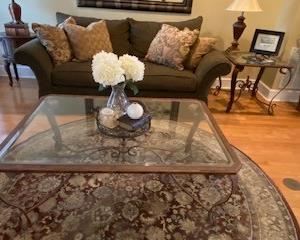 Iron & Glass Coffee Table; Green Chenille Sofa w/ 4 over-size throw pillows; 8 ft. round Oriental Rug.