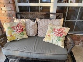 4-piece outdoor wicker porch set includes Love Seat, 2 side chairs, & coffee table w/ glass top & bottom shelf. All cushions & pillows are included & 5 x 7' outdoor rug.