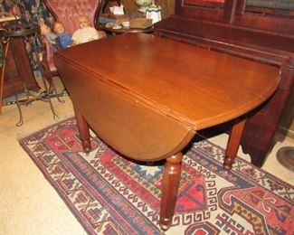 One of several antique drop leaf tables