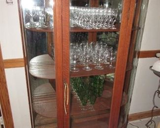 Oak curved glass china cabinet with mirrored back