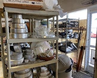 Shelves filled with wedding and other cake decorating supplies- lots of cakes bales here!