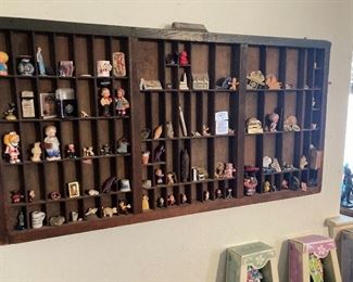 antique printer's drawer and figurines