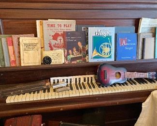 upright piano and sheet music