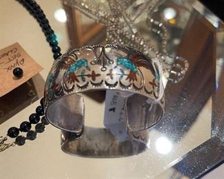 Designer cuff bracelet  signed up with hummingbirds. 