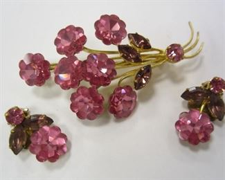 A VINTAGE FLORAL PIN AND CLIP ON EARRINGS SET. MADE IN AUSTRIA. SET WITH PINK STONES.  PIN IS 2.75" TALL