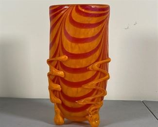 ART GLASS VASE | Orange and red swirled art glass vase with three feet, apparently unsigned; h. 10 x dia. 5 in.