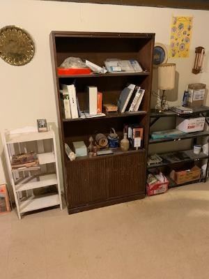 Basement items including books, bookcase, shelf, and decorative items 