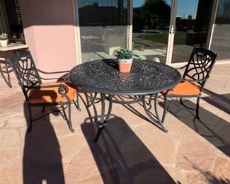 Iron patio set has 4 chairs.  We have on site movers who can deliver this set the day of the sale.  :))