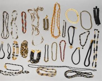 9	Collection of Black and Gold Tone Necklaces	Approximately 26 necklaces, predominately gold tone and black with a variety of cords and beads. Longest necklace: 43" length.
