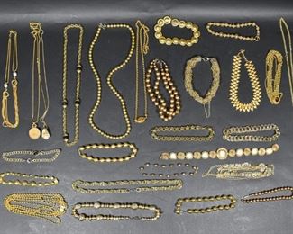 14	Collection of 20 Gold Tone Necklaces	Approximately 20 gold tone necklaces, ranging from pendants, enameled shapes, pearls, and chains. Longest necklace: 19 1/2" length.
