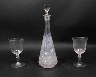 19	Pair of Baccarat Glasses and Cut Glass Decanter	Pair of Baccarat crystal Provence pattern water goblets. Slight residue on the inside of one glass. Marked 'Baccarat' on the base. 'Baccarat Made in France' back stamp. Cut glass decanter with cut stopper. Chips around the circumference of the base pattern. Unsigned. Decanter: 15 1/4" Height, Water goblets: 7" Height x 3 7/8" Diameter
