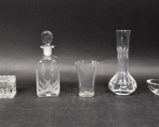 31	5 Piece Glass Lot	5 piece glass lot. Sevres Cristal vase, decanter with etched floral decoration, Baccarat cigarette box with ashtray lid, Orrefors heart dish, unsigned vase. Sevres vase 7 1/2"H; Baccarat box 4 1/2"L x 2 3/8"W x 2"H. Chips and roughness to underside of lid on Baccarat box.
