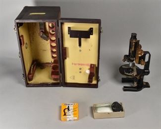 39	Spencer Lens Co Brass Microscope 29687	Spencer Lens Company brass microscope # 29687 with Bausch & Lomb fitted case. Circa 20th Century. Additionally 2 boxes of glass slides. Microscope: 6" L x 4" W x 12"H. Case: 15 1/4" L x 7 1/2" W x 9 1/2" H. Wear to brass surface. Eye piece is clear. 2 objective lens out of 3 included.
