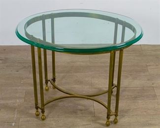 58	French Brass Side Table	A French brass oval side table with beveled glass top. Wear consistent with age. Some scratches and scuffs on glass top. 23 1/4" 29 1/2 " x 21 1/2"

