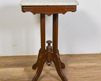 61	Marble Top Mahogany Victorian Side Table	Marble top mahogany Victorian side table. Small chip to underside of marble. 28 1/4" H x 18" W x 13" D.
