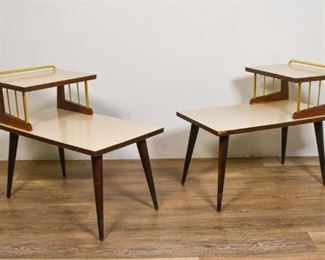 125	Pair Mid Century Modern Step Down End Tables	Pair of mid century modern step down end tables with brass gallery. Some veneer loss to one end table where brass meets wood base. 24" H x 19" L x 27 1/2" D.
