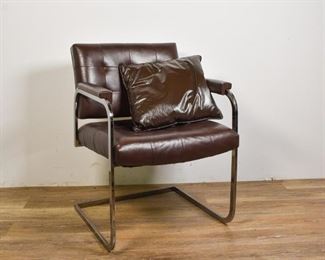 138	Leather Armchair in the Style of Mies Van Der Rohe	Leather armchair in the style of Mies Van Der Roh (German, 1886-1969.) Brown leather seat with leather pillow, leather armrests, chrome legs and frame. Slight wear to right leg. 31" H x 23" L x 23" D
