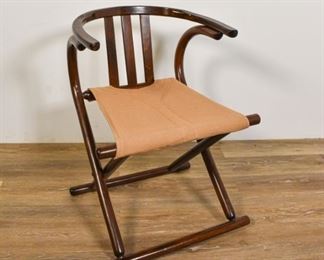 144	Josef Hoffmann Style Mid Century Folding Chair	Josef Hoffman Style Mid Century folding chair. Romanian, Mid 20th Century. Stained wood, canvas seat, horseshoe splat. Remnants of "MADE IN ROMANIA" stamped on bottom. Scuffs to top splat, scratches and wear throughout. 26 1/2" H x 20" L x 17" D
