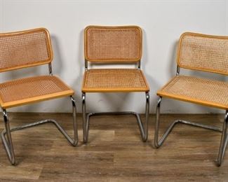 146	3 Marcel Breuer Style Cesca Chairs	3 Cesca chairs in the manner of Marcel Breuer (Hungarian / American, 1902-1981.) Tubular chrome frame, caned seat and back, bentwood frame for caning. Some scuffing and wear to top and sides. 31 1/2" H x 18" L x 18" W
