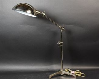152	Industrial Chrome Desk Lamp	Industrial chrome desk lamp, adjustable up/down, lamp angle is adjustable on 3 legged base. Some blemishes to chrome. Overall Height: 24"

